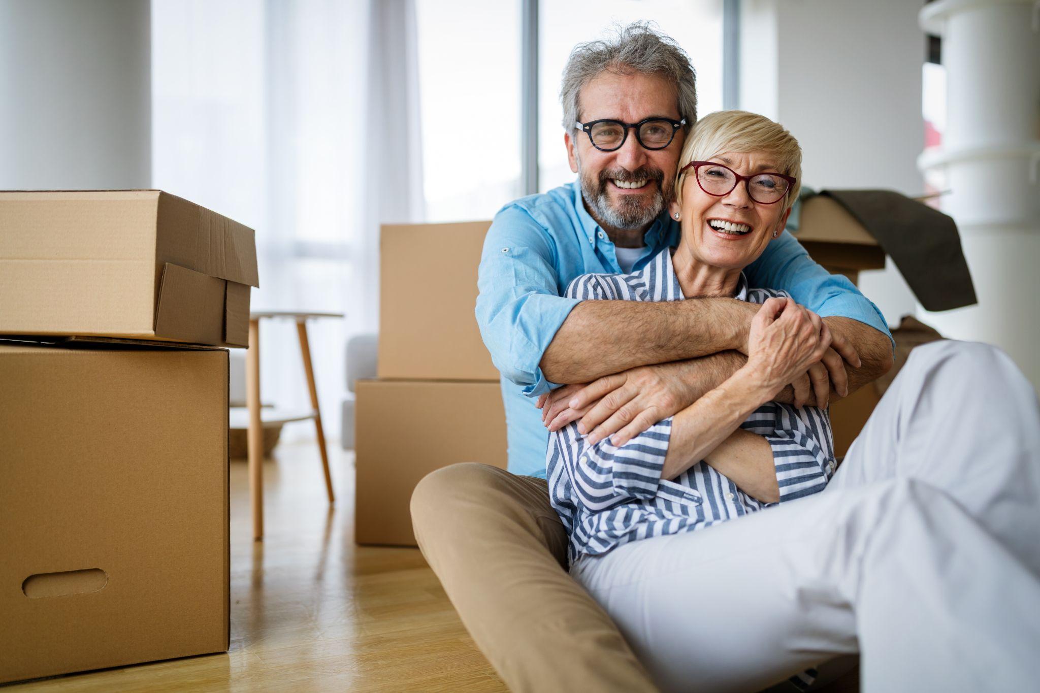 elderly couple with moving boxes